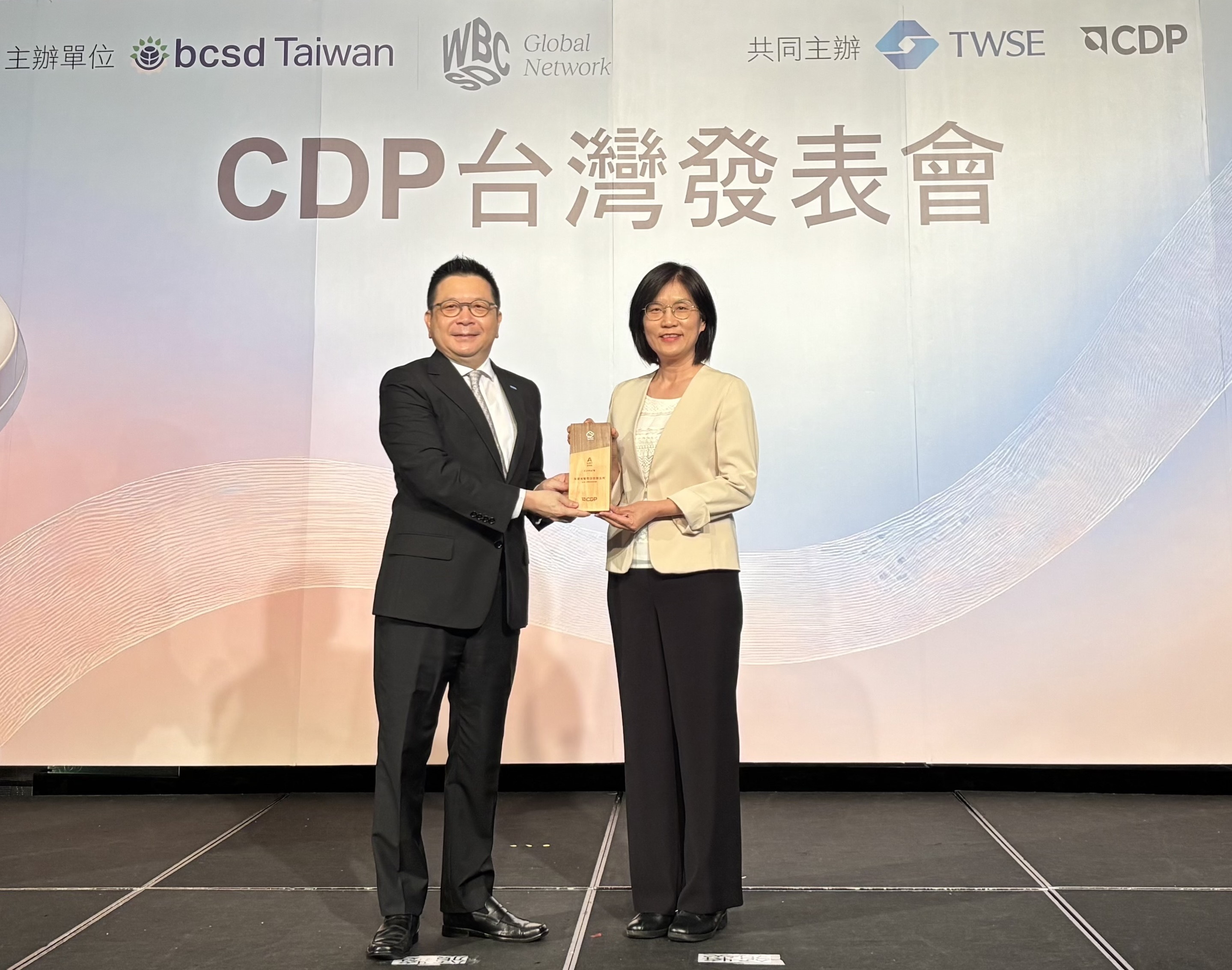友達永續成果再獲國際評比肯定，獲頒CDP氣候與水資源雙項領導力評級。今由臺灣證券交易所董事長林修銘（左）頒獎，友達光電永續長古秀華（右）代表受獎